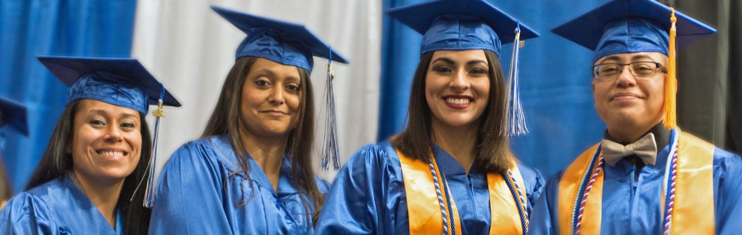 Students in blue graduation cap and gowns